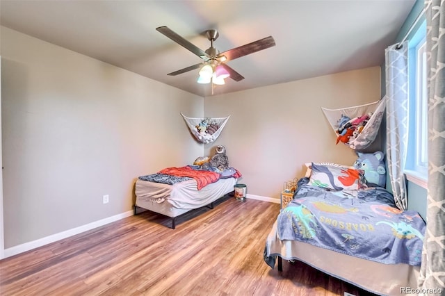 bedroom with hardwood / wood-style floors and ceiling fan