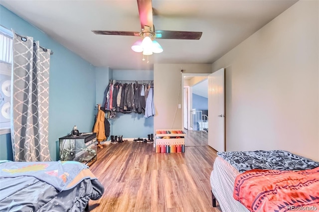 bedroom featuring wood-type flooring and ceiling fan