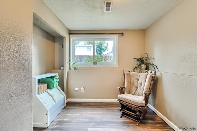 sitting room featuring hardwood / wood-style floors and a textured ceiling