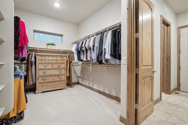 spacious closet with light colored carpet