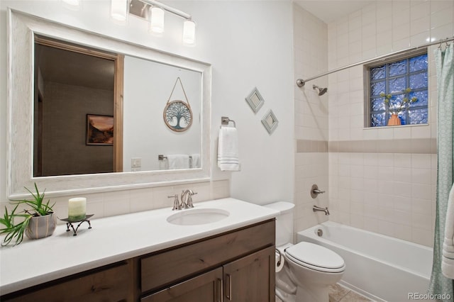 full bathroom featuring tile patterned floors, shower / bath combination with curtain, toilet, and vanity