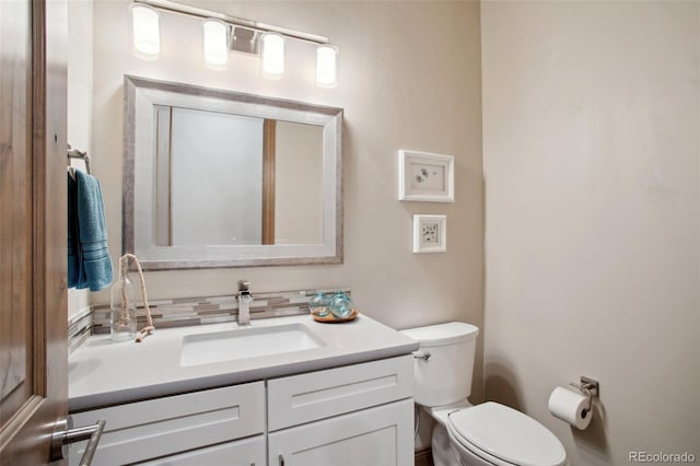 bathroom featuring toilet and vanity