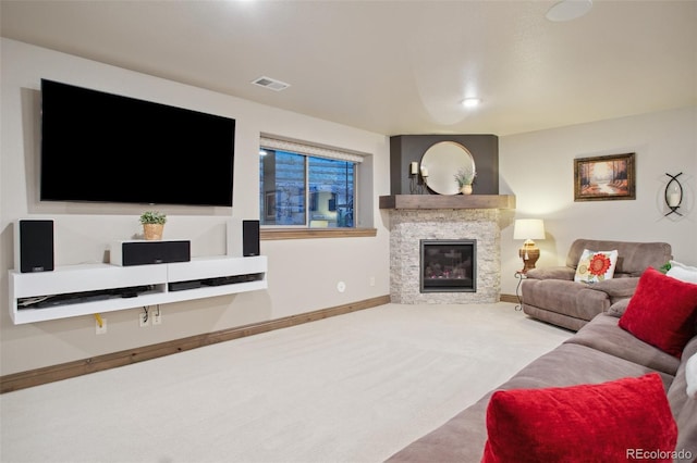 living room featuring light colored carpet and a fireplace