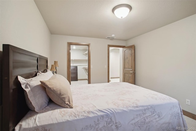 bedroom featuring a closet and a spacious closet