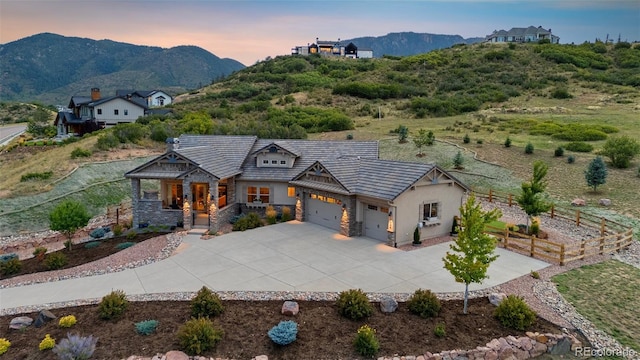 view of front facade with a mountain view and a garage