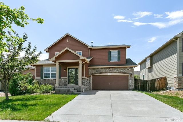 9919 Memphis St, Commerce City, CO 80022 - view of front of house featuring a garage, concrete driveway, and stone siding