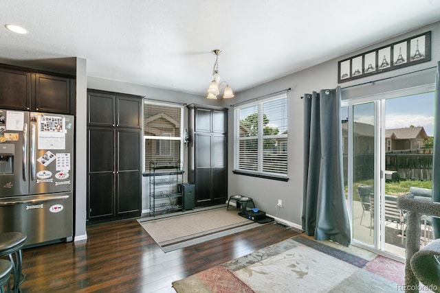 9919 Memphis St, Commerce City, CO 80022 - dining area with dark wood finished floors, a chandelier, and baseboards