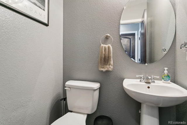 9919 Memphis St, Commerce City, CO 80022 - half bathroom featuring toilet and a textured wall