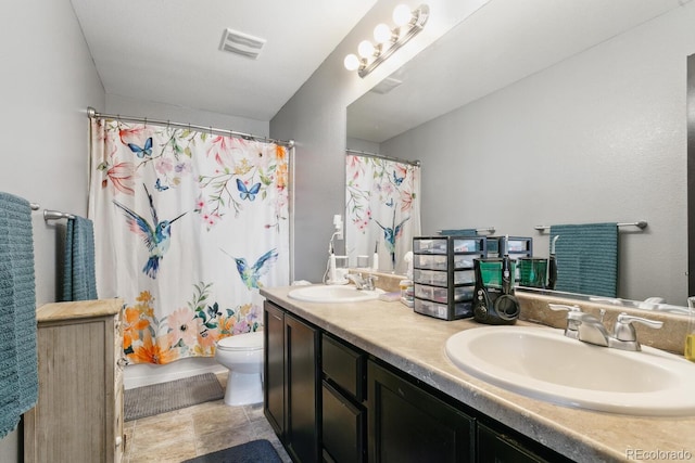 9919 Memphis St, Commerce City, CO 80022 - bathroom with double vanity, toilet, and curtained shower