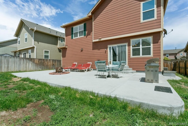 9919 Memphis St, Commerce City, CO 80022 - rear view of house featuring a fire pit, a patio area, and a fenced backyard