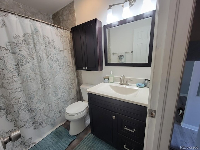 bathroom featuring vanity, hardwood / wood-style flooring, and toilet