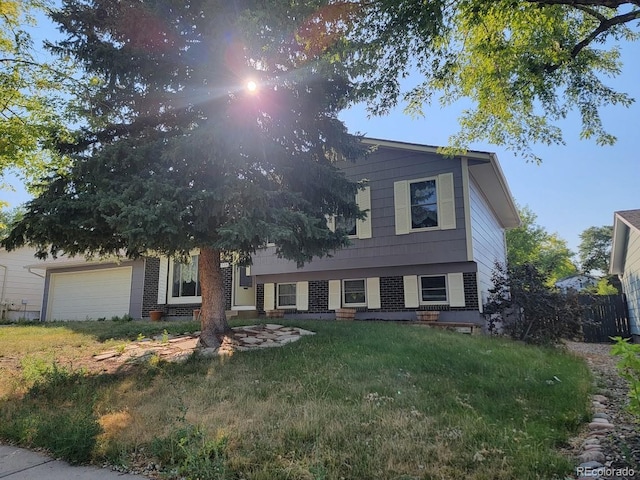 view of front of house with a garage and a front lawn