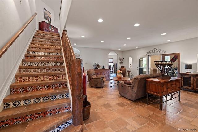 28098 Green Valley Ln, Conifer, CO 80433 - stairway featuring arched walkways, recessed lighting, and stone tile floors