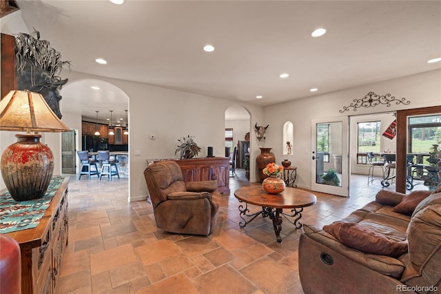 28098 Green Valley Ln, Conifer, CO 80433 - living area featuring arched walkways, recessed lighting, and stone tile floors