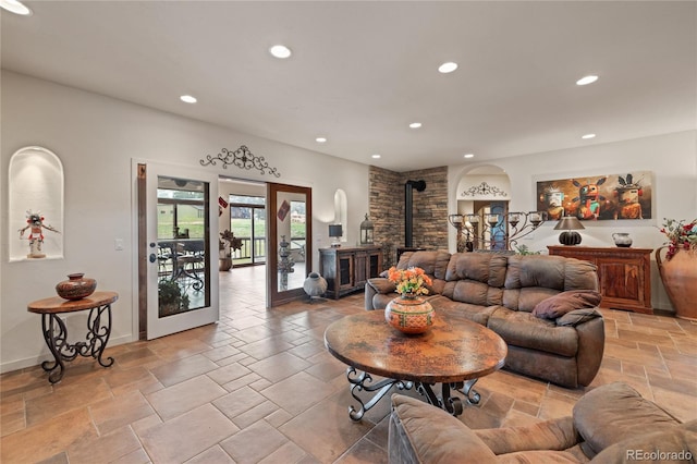 28098 Green Valley Ln, Conifer, CO 80433 - living room featuring a wood stove, recessed lighting, stone tile flooring, and baseboards