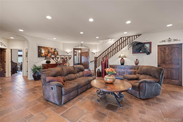 28098 Green Valley Ln, Conifer, CO 80433 - living area featuring arched walkways, recessed lighting, stairs, and stone tile floors