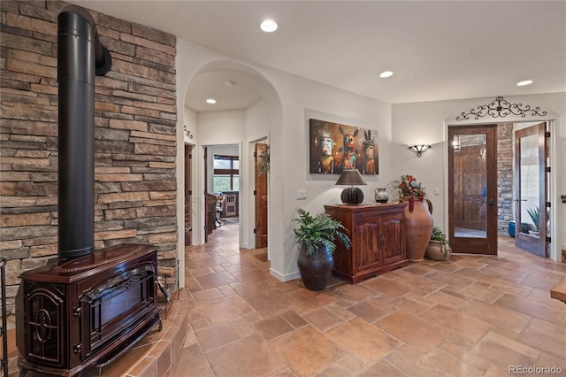 28098 Green Valley Ln, Conifer, CO 80433 - entryway featuring a wood stove, stone tile flooring, recessed lighting, baseboards, and french doors