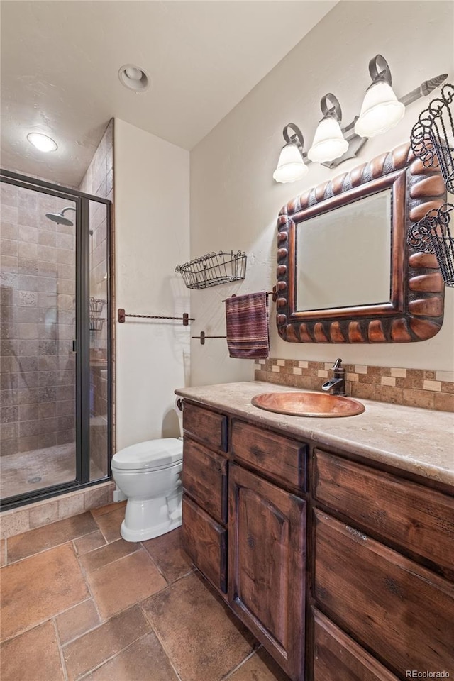 28098 Green Valley Ln, Conifer, CO 80433 - full bath with vanity, toilet, a stall shower, stone tile flooring, and backsplash