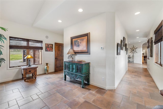 28098 Green Valley Ln, Conifer, CO 80433 - corridor featuring stone tile flooring, arched walkways, baseboards, and recessed lighting