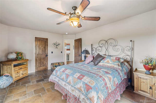 28098 Green Valley Ln, Conifer, CO 80433 - bedroom featuring stone finish flooring and a ceiling fan