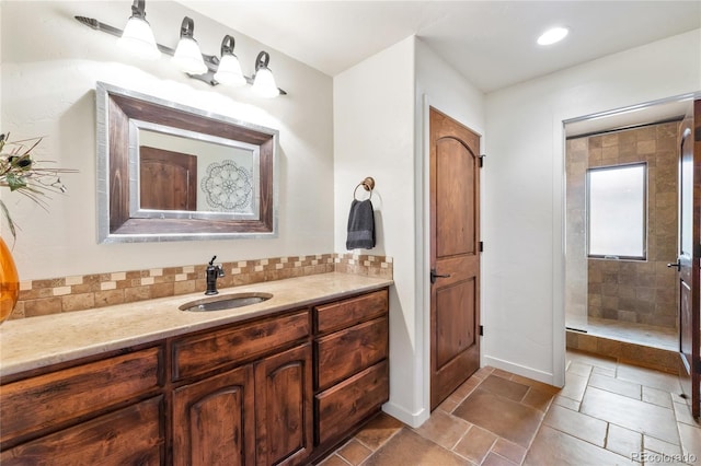 28098 Green Valley Ln, Conifer, CO 80433 - bathroom featuring vanity, baseboards, and tiled shower