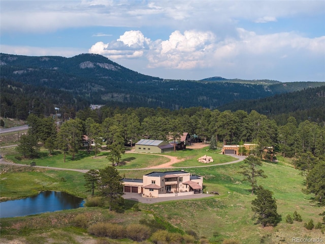 28098 Green Valley Ln, Conifer, CO 80433 - aerial view of property and surrounding area featuring a heavily wooded area and a water and mountain view