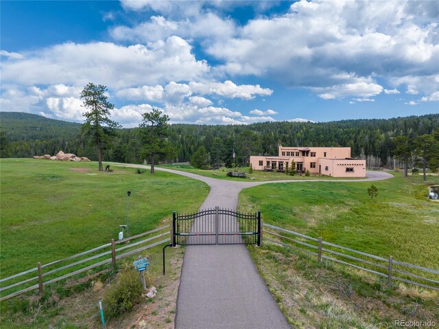 28098 Green Valley Ln, Conifer, CO 80433 - view of mountain background featuring a heavily wooded area, rural landscape, and a pastoral area