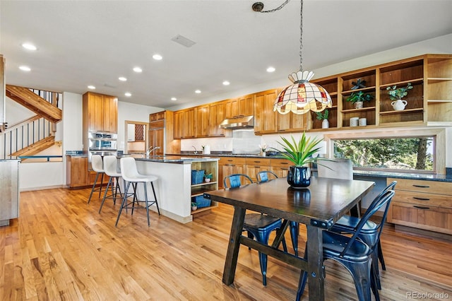 9041 Eastridge Rd, Golden, CO 80403 - dining room featuring recessed lighting, light wood finished floors, and stairway