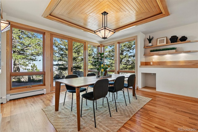 9041 Eastridge Rd, Golden, CO 80403 - dining space featuring a tray ceiling, a baseboard heating unit, wooden ceiling, and light wood-style flooring