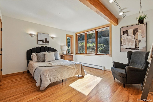 9041 Eastridge Rd, Golden, CO 80403 - bedroom with a baseboard radiator, light wood-style flooring, beam ceiling, and baseboards