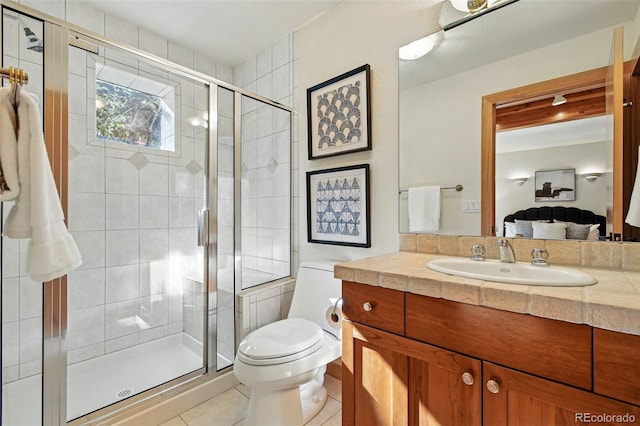 9041 Eastridge Rd, Golden, CO 80403 - ensuite bathroom featuring vanity, tile patterned flooring, toilet, and a shower stall