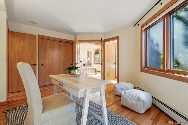9041 Eastridge Rd, Golden, CO 80403 - office featuring baseboard heating, plenty of natural light, light wood-type flooring, and a baseboard radiator