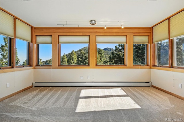 9041 Eastridge Rd, Golden, CO 80403 - unfurnished sunroom with carpet flooring, track lighting, and a baseboard radiator
