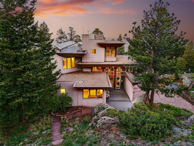 9041 Eastridge Rd, Golden, CO 80403 - back of property at dusk with a balcony and stucco siding