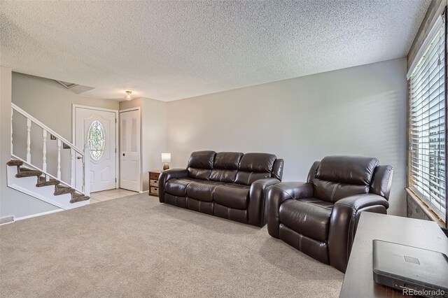 9630 W 104th Ave, Broomfield, CO 80021 - carpeted living area featuring a textured ceiling and stairway