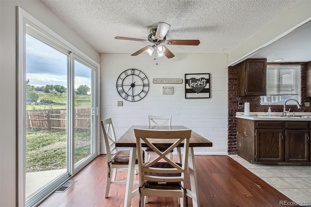 9630 W 104th Ave, Broomfield, CO 80021 - dining room featuring light wood-style floors, ceiling fan, and a textured ceiling
