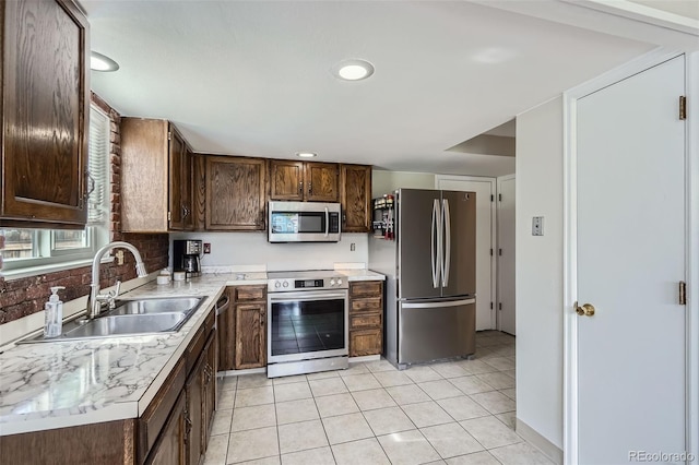 9630 W 104th Ave, Broomfield, CO 80021 - kitchen with stainless steel appliances, light tile patterned floors, light countertops, dark brown cabinets, and recessed lighting