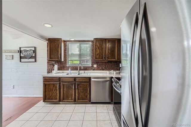 9630 W 104th Ave, Broomfield, CO 80021 - kitchen with stainless steel appliances, light countertops, light tile patterned flooring, and dark brown cabinets