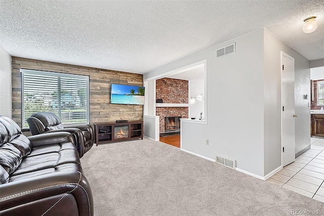 9630 W 104th Ave, Broomfield, CO 80021 - living room with a large fireplace, wooden walls, healthy amount of natural light, a textured ceiling, and light colored carpet