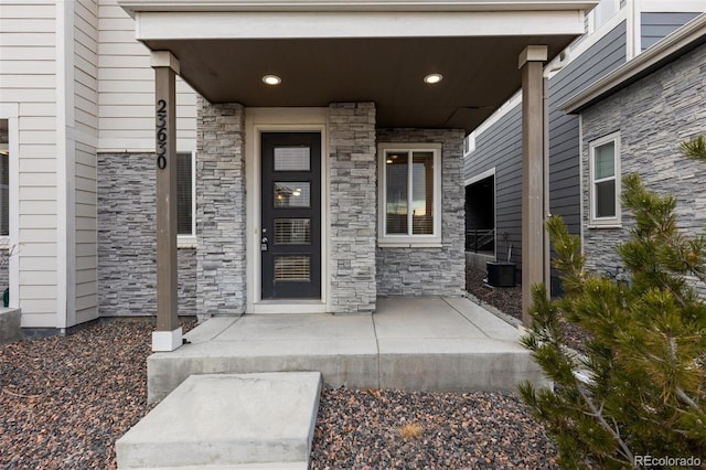 view of exterior entry with a porch