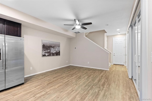 unfurnished living room with ceiling fan and light hardwood / wood-style flooring