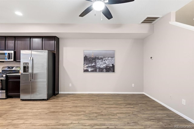 kitchen with dark brown cabinets, stainless steel appliances, ceiling fan, and light hardwood / wood-style floors