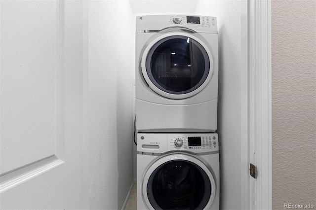 washroom with stacked washing maching and dryer