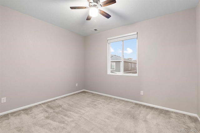 carpeted spare room with ceiling fan