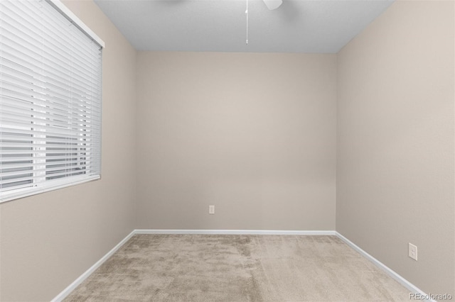 unfurnished room featuring light carpet and ceiling fan