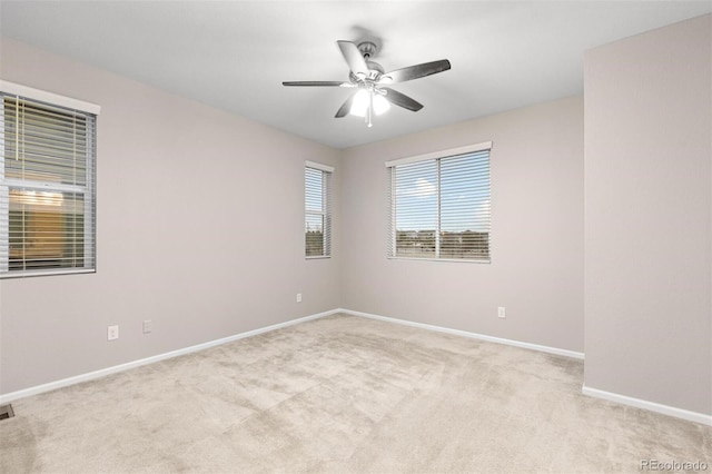 unfurnished room with ceiling fan and light colored carpet