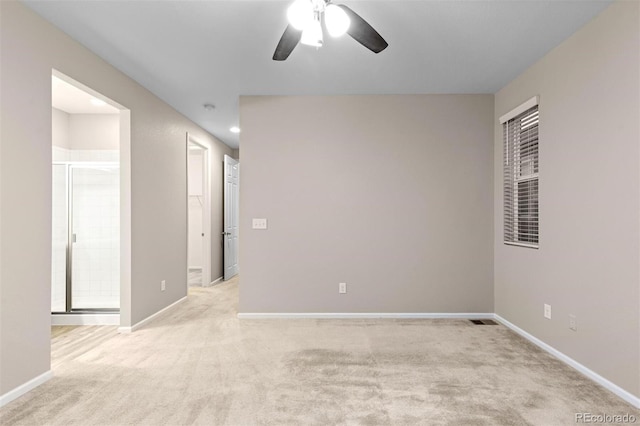 unfurnished room featuring light carpet and ceiling fan