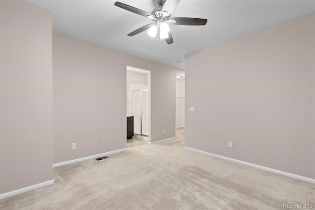 carpeted spare room featuring ceiling fan