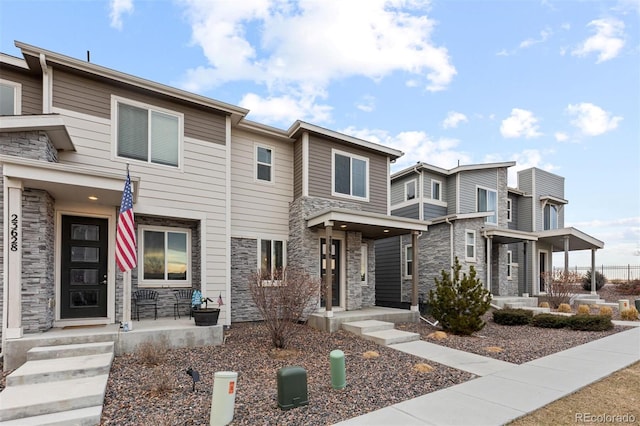 23630 E 5th Pl, Aurora, CO 80018 - multi unit property featuring stone siding and covered porch