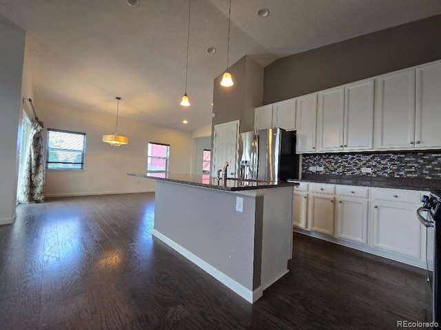 483 W 172nd Pl, Broomfield, CO 80023 - kitchen with stainless steel fridge, dark countertops, high vaulted ceiling, dark wood-style floors, and backsplash
